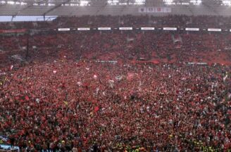Its bleeding red! Bayer Laverkusen fans throng pitch as team wins maiden Bundesliga title